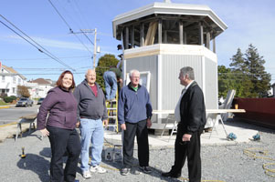 People standing in front of Lehighton Judge's Stand while it is being refurbished