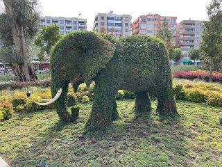 A large elephant topiary in a grassy field